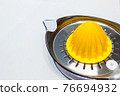 Orange juice squeezer isolated on white background..Stainless steel orange squeezer close up on white background. 76694932