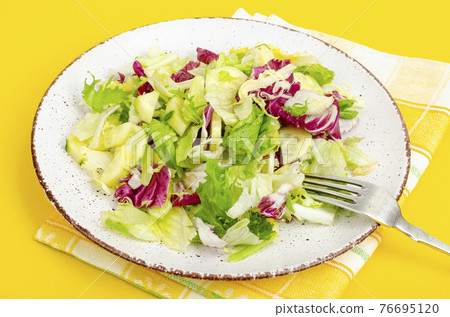Light dietary vegetarian salad in plate on bright background. Healthy lifestyle concept 76695120