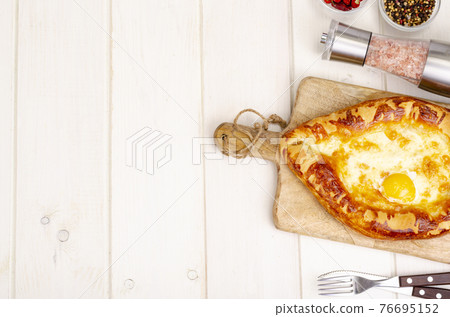 Homemade cakes, khachapuri with cheese and egg Homemade cakes, khachapuri with cheese and egg 76695152
