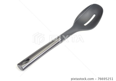 Plastic culinary black spoon, slotted spatula, kitchen gadget. Kitchen utensil. Isolated Plastic culinary black spoon, slotted spatula, kitchen gadget. Kitchen utensil. Isolated 76695251
