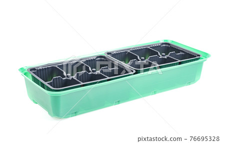 Black plastic cassettes for growing plant seedlings on white background. 76695328