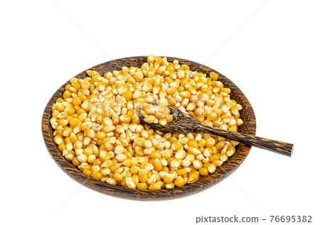 Dry corn grains in bowl for making popcorn. 76695382