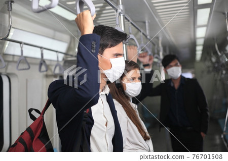 people with mask travel Public electric train, Businessman or woman wearing white facial mask during travel by Public electric train, new normal life style during covid-19 pandemic 76701508