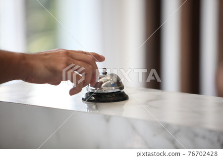 Hotel service bell on a table white glass and simulation hotel background. Concept hotel, travel, room 76702428