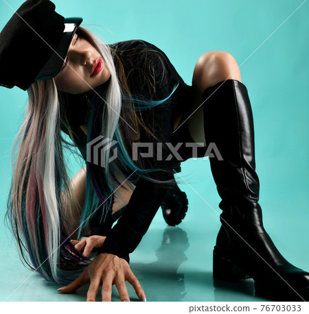 Young blonde woman with colored strands in black 76703033