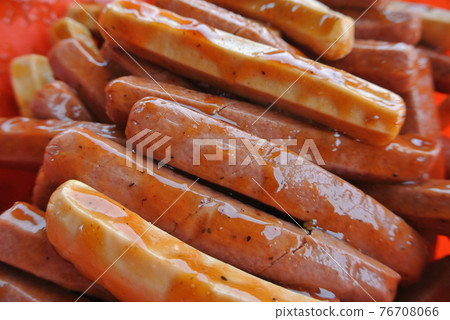 Marinated sausages with a variety of spices. This process is done to add a delicious flavour to the sausages. 76708066
