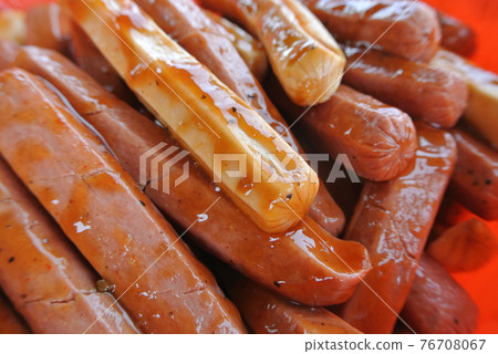 Marinated sausages with a variety of spices. This process is done to add a delicious flavour to the sausages. Marinated sausages with a variety of spices. This process is done to add a delicious flavour to the sausages. 76708067