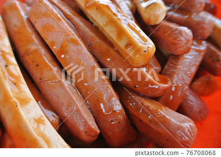 Marinated sausages with a variety of spices. This process is done to add a delicious flavour to the sausages. Marinated sausages with a variety of spices. This process is done to add a delicious flavour to the sausages. 76708068