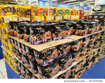 KUALA LUMPUR, MALAYSIA -MARCH 5, 2020: Selected focused on various brands of instant noodles in commercial packages stacked for sale in the supermarkets. Sorted by brands.   76709308