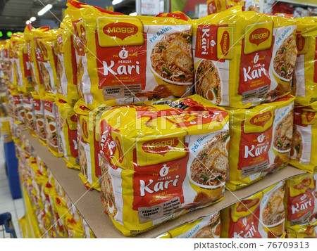 KUALA LUMPUR, MALAYSIA -MARCH 5, 2020: Selected focused on various brands of instant noodles in commercial packages stacked for sale in the supermarkets. Sorted by brands.   76709313