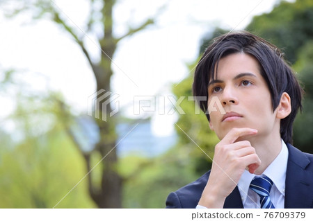 Young man in a pondering suit Young man in a pondering suit 76709379