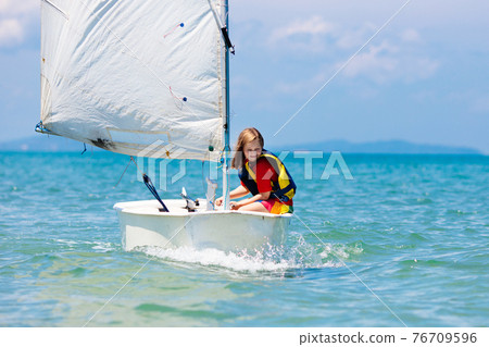 Child sailing. Kid learning to sail on sea yacht. Child sailing. Kid learning to sail on sea yacht. 76709596