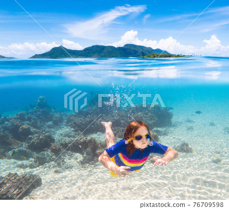 Child snorkeling. Kids underwater. Beach and sea. 76709598