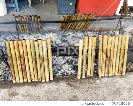 Malaysian famous traditional food called lemang. Glutinous rice wrapped with banana leave and cook & steamed in bamboo. Malaysian famous traditional food called lemang. Glutinous rice wrapped with banana leave and cook & steamed in bamboo. 76710036