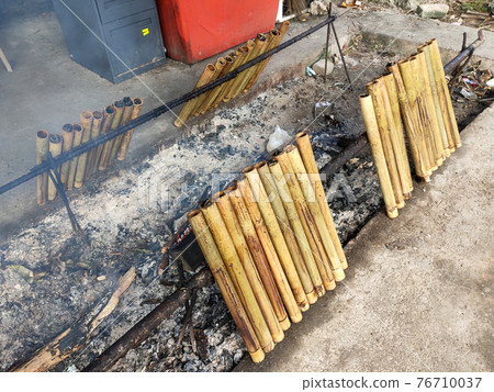 Malaysian famous traditional food called lemang. Glutinous rice wrapped with banana leave and cook & steamed in bamboo. Malaysian famous traditional food called lemang. Glutinous rice wrapped with banana leave and cook & steamed in bamboo. 76710037