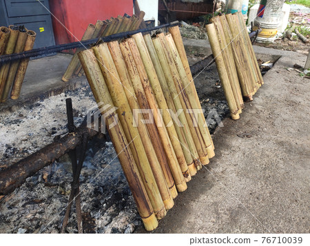 Malaysian famous traditional food called lemang. Glutinous rice wrapped with banana leave and cook & steamed in bamboo.  76710039