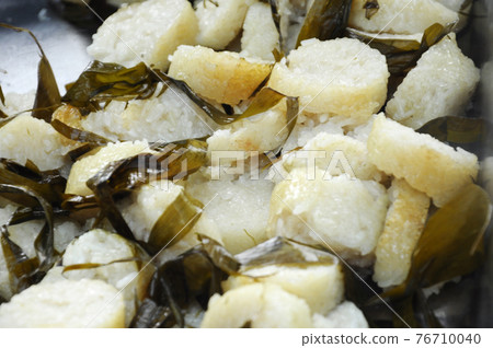 Malaysian famous traditional food called lemang. Glutinous rice wrapped with banana leave and cook & steamed in bamboo. Malaysian famous traditional food called lemang. Glutinous rice wrapped with banana leave and cook & steamed in bamboo. 76710040