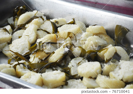 Malaysian famous traditional food called lemang. Glutinous rice wrapped with banana leave and cook & steamed in bamboo. Malaysian famous traditional food called lemang. Glutinous rice wrapped with banana leave and cook & steamed in bamboo. 76710041