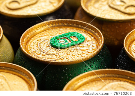 Cold metal beer cans with water drops. Alcoholic drink. 76710268