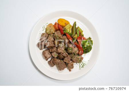 Beef cube steak on a white plate Beef cube steak on a white plate 76710974