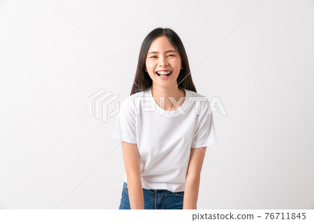 Studio shot of cheerful beautiful Asian woman in white t-shirt and stand on white background. 76711845