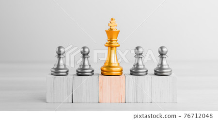 Chess standing on orange wooden block and team victory in business with influence. 76712048