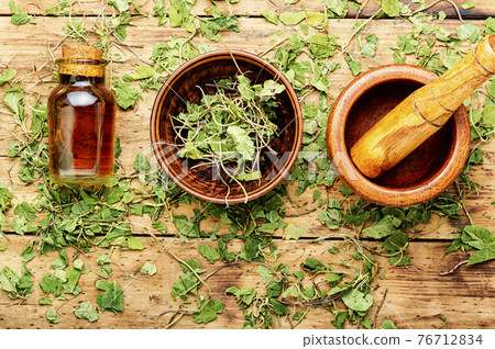 Orthilia secunda,healing herbs on wooden table 76712834