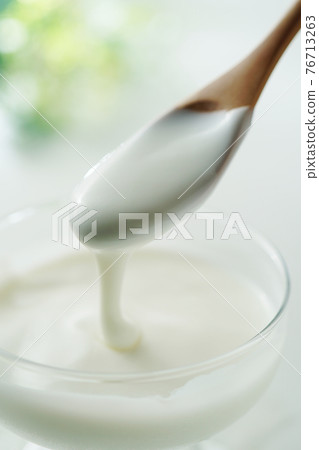 Yogurt with a spoon 76713263