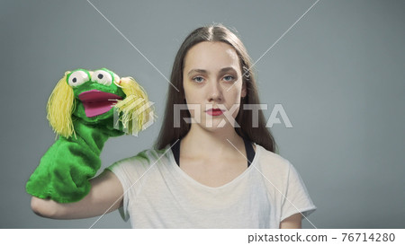 Photo of woman with handmade doll on grey Photo of woman with handmade doll on grey 76714280