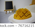 Cut mango and blackboard 76716215