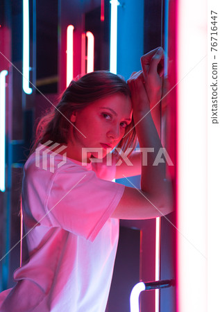 Vertical shot - portrait in the neo. Model in a nightclub 76716447