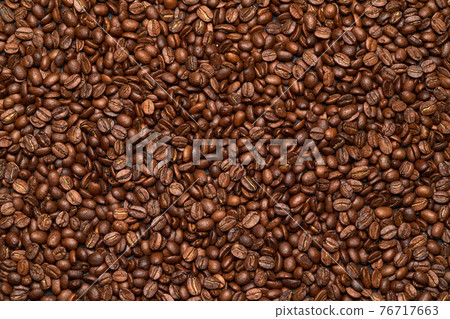 Background or texture made of roasted brown coffee beans Background or texture made of roasted brown coffee beans 76717663