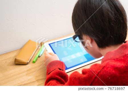 Children with glasses learning on tablets 76718697