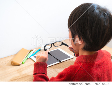 Children with glasses learning on tablets 76718698