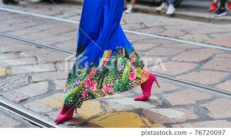 Detail of a fashionable outfit woman wearing colorful dress and pink shoes Detail of a fashionable outfit woman wearing colorful dress and pink shoes 76720097