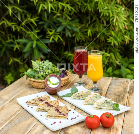 Tasty qutab, Azerbaijani meal with yogurt, juice on the wooden plate Tasty qutab, Azerbaijani meal with yogurt, juice on the wooden plate 76720128