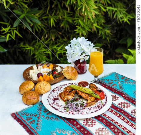 Tasty chicken meat meal with ketchup, bread, juice with green background Tasty chicken meat meal with ketchup, bread, juice with green background 76720143