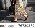 Detail of a fashionable outfit woman wearing colorful dress and summer shoes 76720279