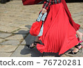 Detail of a fashionable outfit woman with red dress and red purse 76720281