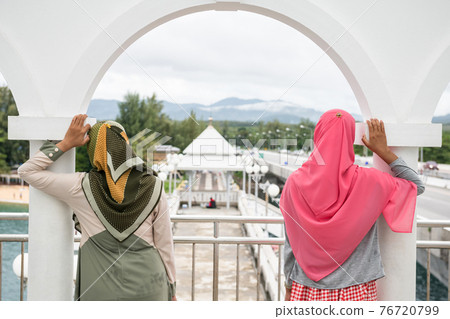 muslim woman friends look view at Sarasin bridge muslim woman friends look view at Sarasin bridge 76720799