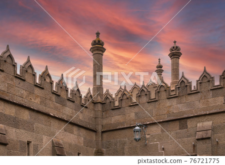 The walls and towers of the old palace on the background of beautiful pink sunset 76721775
