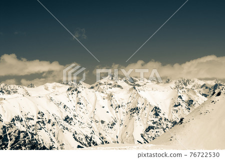 High winter snowy mountains. Retro color toned landscape. 76722530
