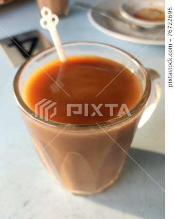 Malaysian signature drink called 'TEH TARIK'. Tea drinks mixed with creamy white creamers. The Creamer base is made of a palm oil base. Malaysian signature drink called 'TEH TARIK'. Tea drinks mixed with creamy white creamers. The Creamer base is made of a palm oil base. 76722698