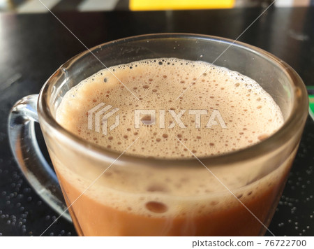 Malaysian signature drink called 'TEH TARIK'. Tea drinks mixed with creamy white creamers. The Creamer base is made of a palm oil base. Malaysian signature drink called 'TEH TARIK'. Tea drinks mixed with creamy white creamers. The Creamer base is made of a palm oil base. 76722700