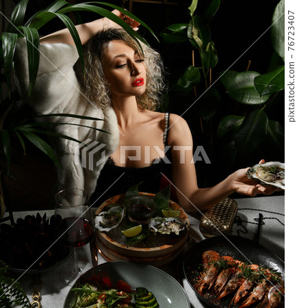 Young blonde woman in evening dress and fur is in 76723407