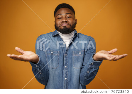 Young african american man shrugging his shoulders, he doesn't know Young african american man shrugging his shoulders, he doesn't know 76723840