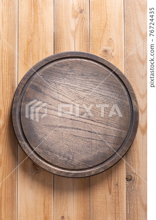 Meat or bread pizza cutting board for homemade baking on table. Wooden pizza board Meat or bread pizza cutting board for homemade baking on table. Wooden pizza board 76724435