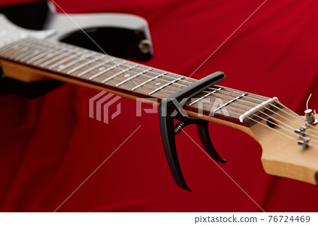 Electric guitar fretboard with capodaster, closeup 76724469