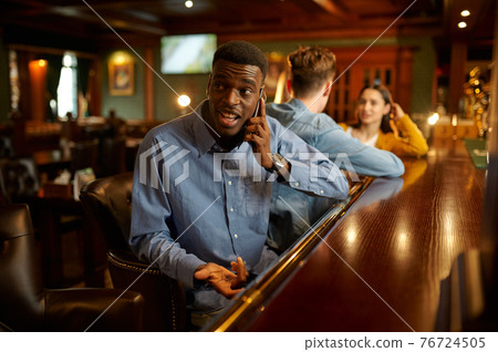 Friends leisures at the counter in bar, nightlife Friends leisures at the counter in bar, nightlife 76724505