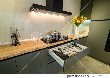 Modern large luxury dark gray kitchen with pulled out drawer Modern large luxury dark gray kitchen with pulled out drawer 76725592